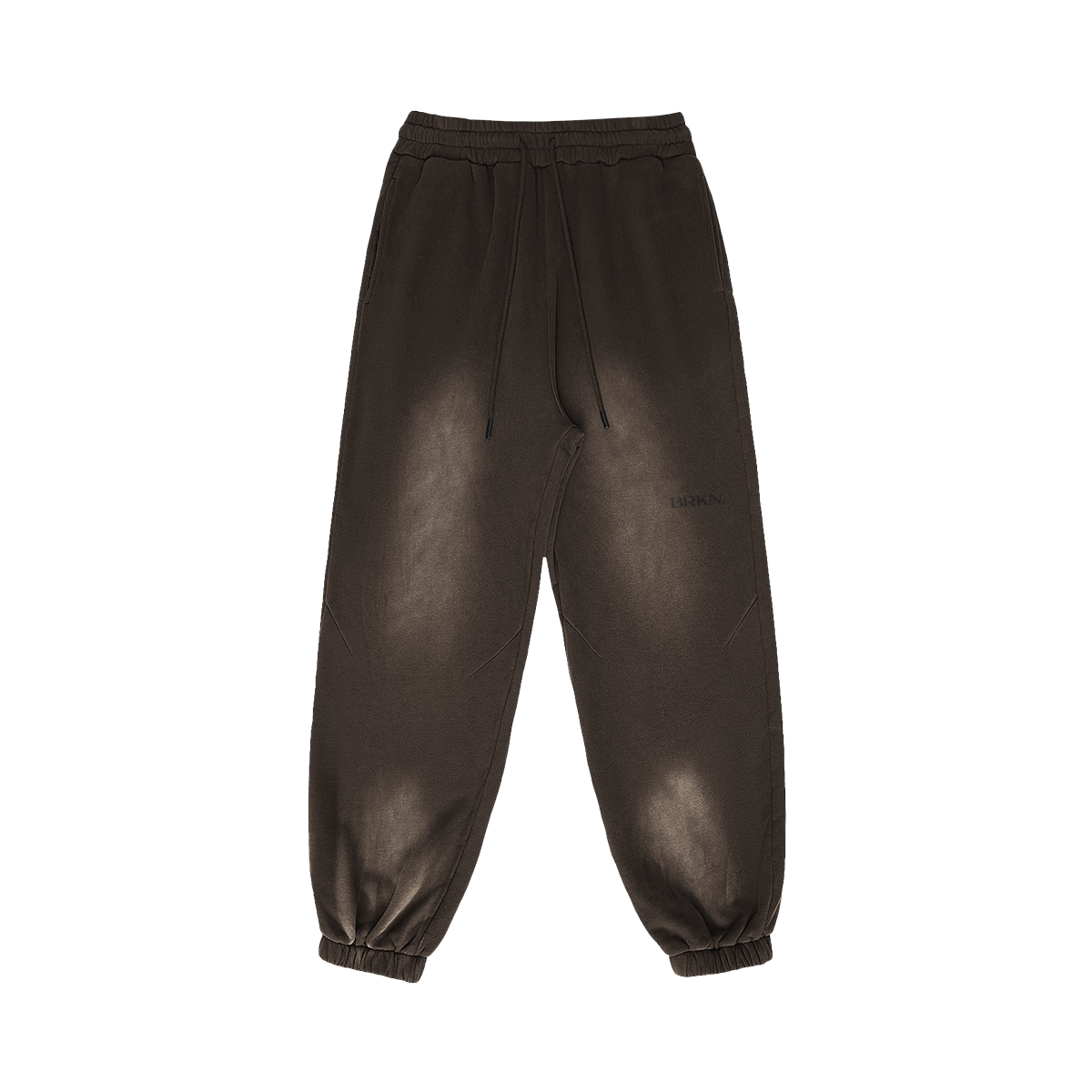 Dark brown minimalist jogger sweatpants with elastic cuffs and drawstring waist, featuring subtle BRKN logo.