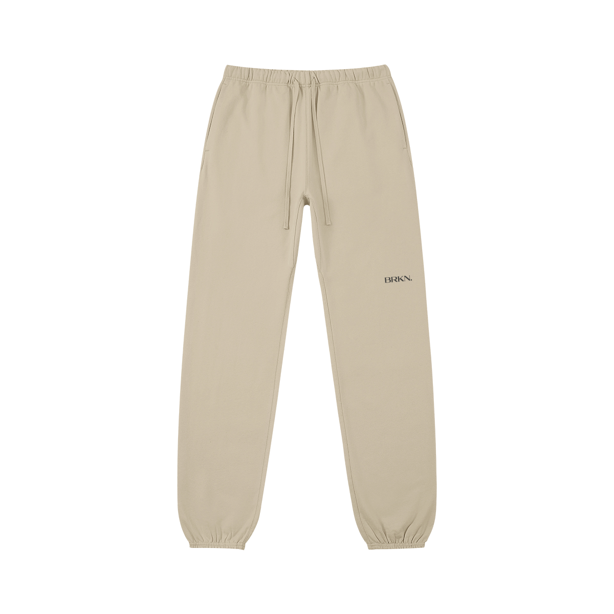 Beige minimalist sweatpants with BRKN logo, drawstring waist, and cuffed ankles for everyday streetwear